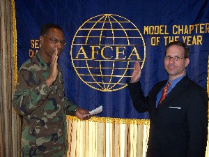 Outgoing Seoul Chapter president Col. Greg Edwards, USAF, inducts newly elected chapter president Nathan Colodney in February.